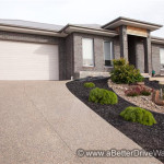 A Better Driveway Modern single-story house with brick exterior and steep driveway.