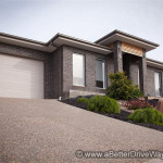 Modern single-story house with brick exterior and steep driveway.