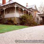 A favourite blend of ours from one of our suppliers Traditional house with a wrap-around porch and a gravel driveway.