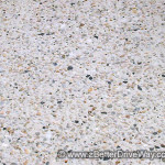 One of our favourites is simply a river pebble blend in white cement Close-up of an exposed aggregate concrete surface with multi-colored stones.